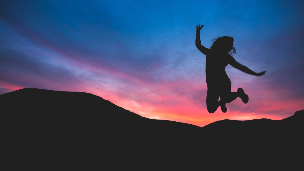 Picture of Girl jumping at sunset for outrageous success