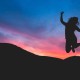 Picture of Girl jumping at sunset for outrageous success